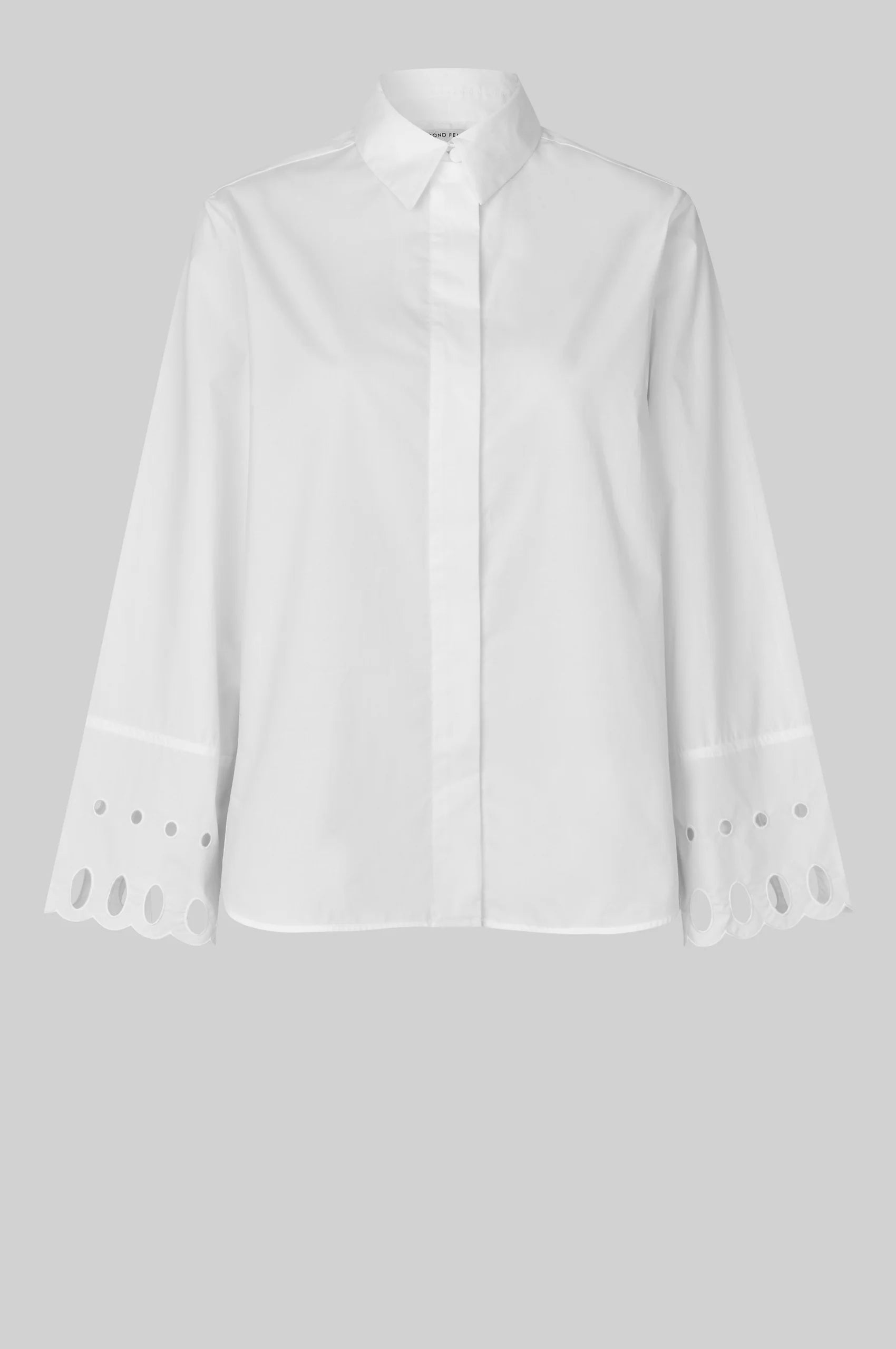 White shirt with cut-out details on the sleeves against a gray background