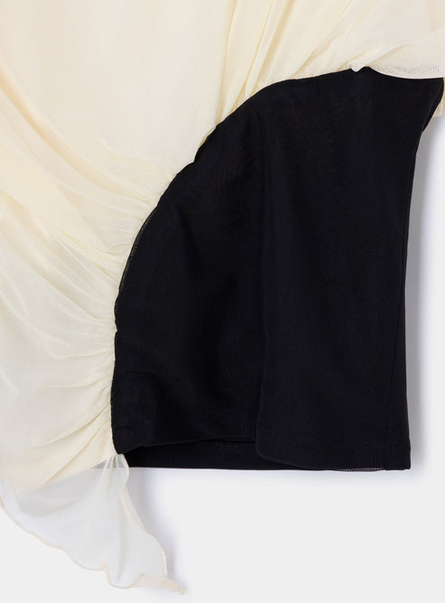 Black and beige color block top on a white background